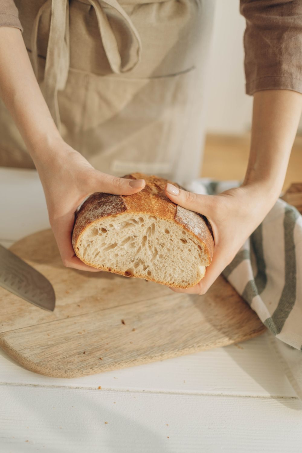Home baker holding fresh bread