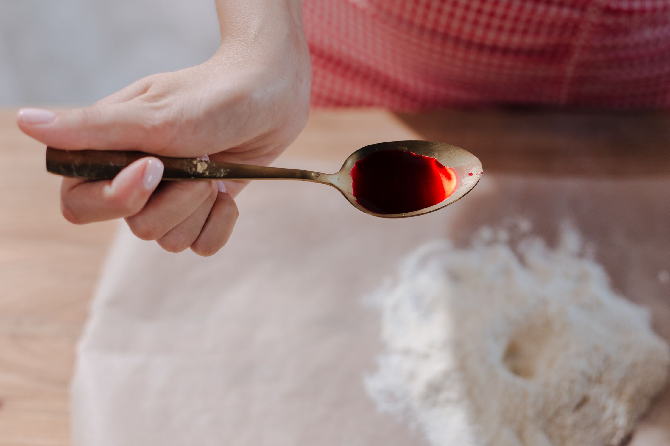 Red artificial food dye on a spoon